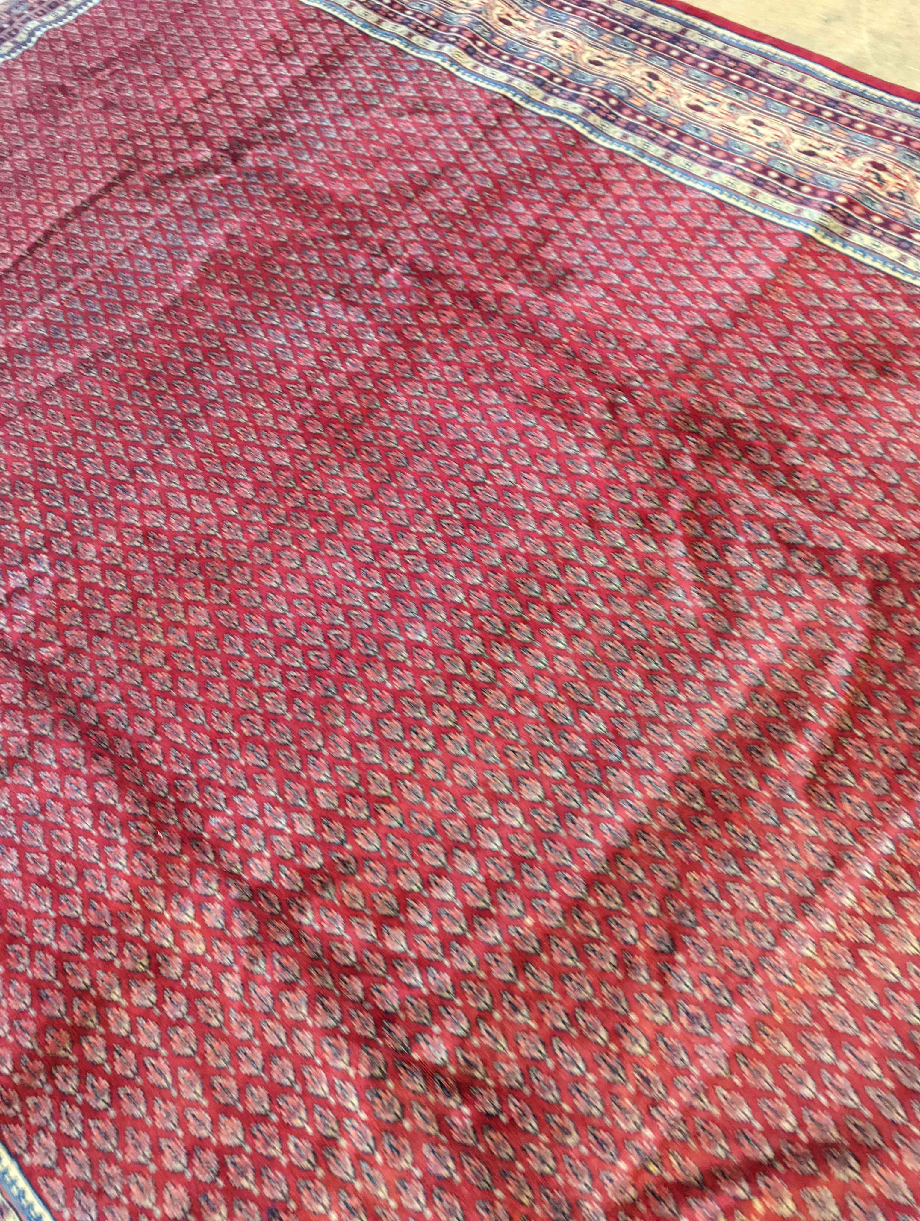 An Araak crimson ground carpet, 350 x 250cm